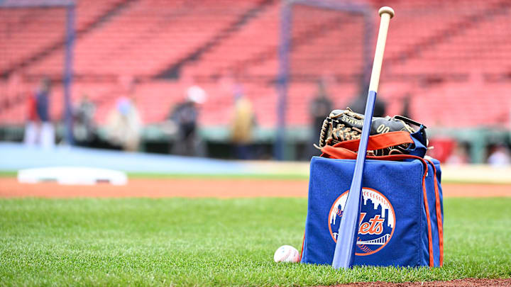 May 21, 2025; Boston, Massachusetts, USA; A New York Mets bat and glove sit on the infield grass before a game against the Boston Red Sox at Fenway Park. Mandatory Credit: Eric Canha-Imagn Images