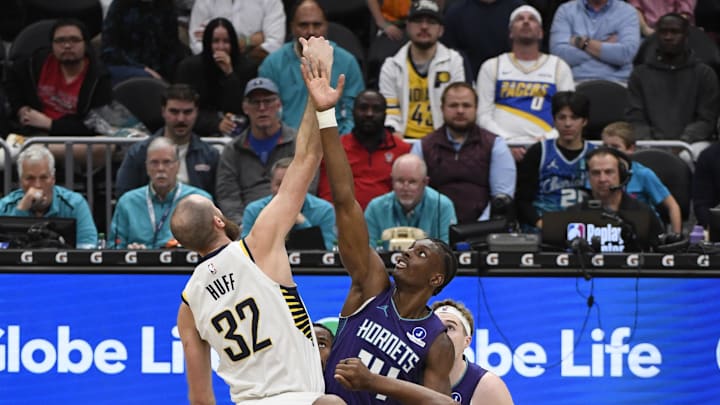 Jan 8, 2026; Charlotte, North Carolina, USA;  Indiana Pacers center Jay Huff (32) and Charlotte Hornets forward center Moussa Diabate (14) go for a jump ball during the second half at the Spectrum Center. Mandatory Credit: Sam Sharpe-Imagn Images