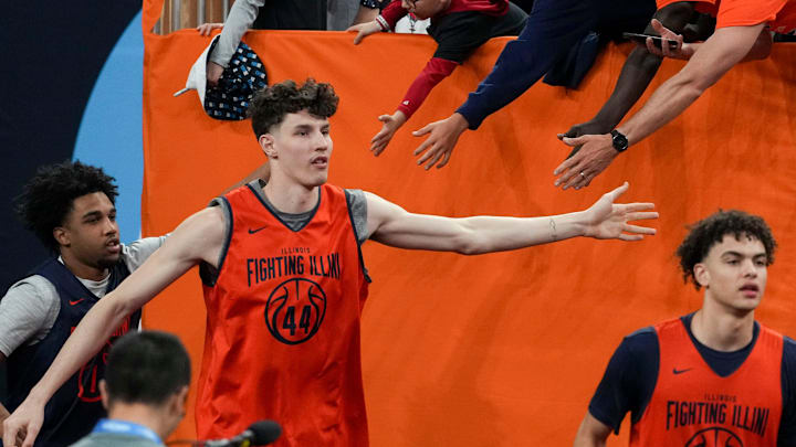 Illinois Fighting Illini forward Zvonimir Ivisic (44) gets high fives as he walks onto the court before practice ahead of a Final Four game on Friday, April 3, 2026, at Lucas Oil Stadium in Indianapolis.