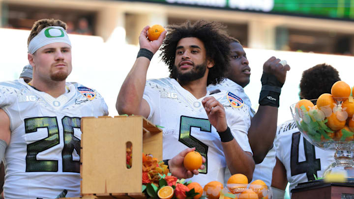 Dante Moore displays his touch and accuracy on the celebration podium at the Orange Bowl. Dante Moore displays his touch and accuracy on the celebration podium at the Orange Bowl.