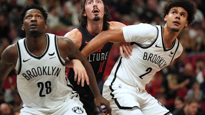Nov 16, 2023; Miami, Florida, USA;  Miami Heat guard Jaime Jaquez Jr. (11) battles for position with Brooklyn Nets forward Dorian Finney-Smith (28) and forward Cameron Johnson (2) in the first half at Kaseya Center. Mandatory Credit: Jim Rassol-Imagn Images
