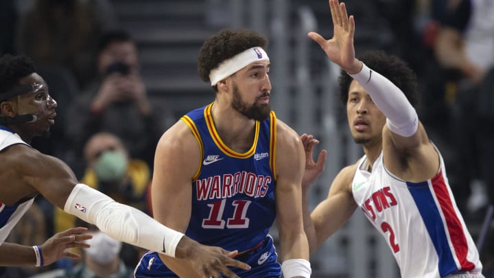 Jan 18, 2022; San Francisco, California, USA; Detroit Pistons guards Hamidou Diallo (left) and Cade Cunningham (2) harass Golden State Warriors guard Klay Thompson (11) during the first quarter at Chase Center. Mandatory Credit: D. Ross Cameron-USA TODAY Sports