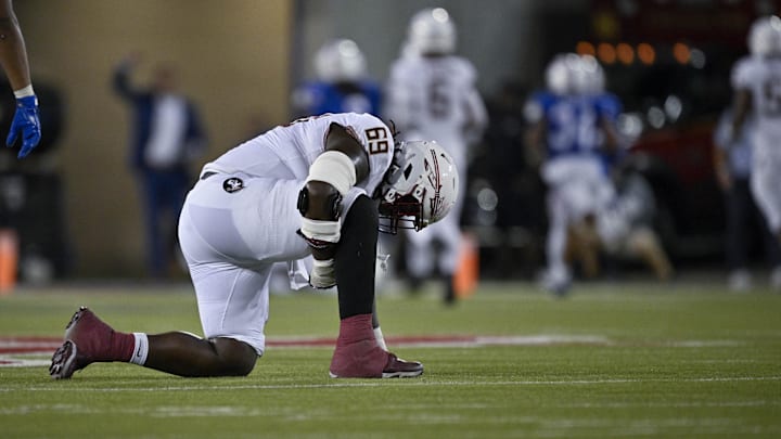 Sep 28, 2024; Dallas, Texas, USA; Florida State Seminoles offensive lineman TJ Ferguson (69) is injured as Southern Methodist Mustangs linebacker Kobe Wilson (24) returns an interception for a touchdown during the second half at Gerald J. Ford Stadium. Mandatory Credit: Jerome Miron-Imagn Images