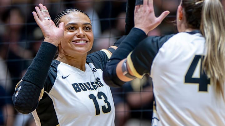 Purdue Senior Akasha Anderson (13) high-fives teammates after a point 