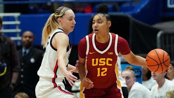 Dec 21, 2024; Hartford, Connecticut, USA; USC Trojans guard JuJu Watkins (12) dribbles the ball against UConn Huskies guard Paige Bueckers (5) in the first half at XL Center. Mandatory Credit: David Butler II-Imagn Images