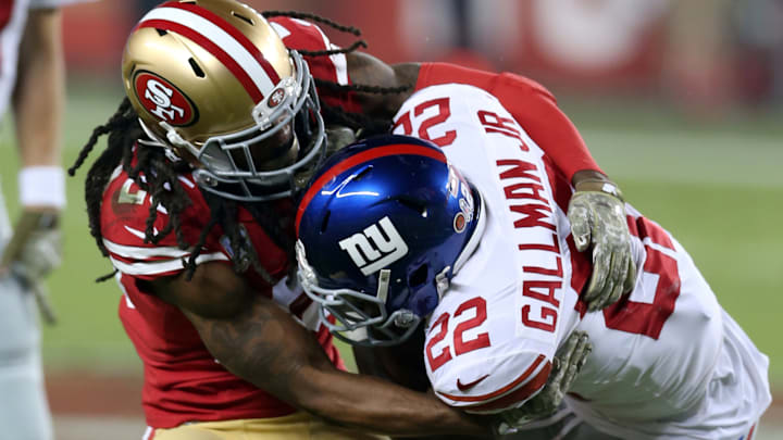 San Francisco 49ers cornerback Richard Sherman (L) tackles New York Giants running back Wayne Gallman (R)