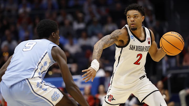 Mar 18, 2025; Dayton, OH, USA; San Diego State Aztecs guard Nick Boyd (2) plays the ball defended by North Carolina Tar Heels guard Drake Powell (9) in the first half at UD Arena. Mandatory Credit: Rick Osentoski-Imagn Images