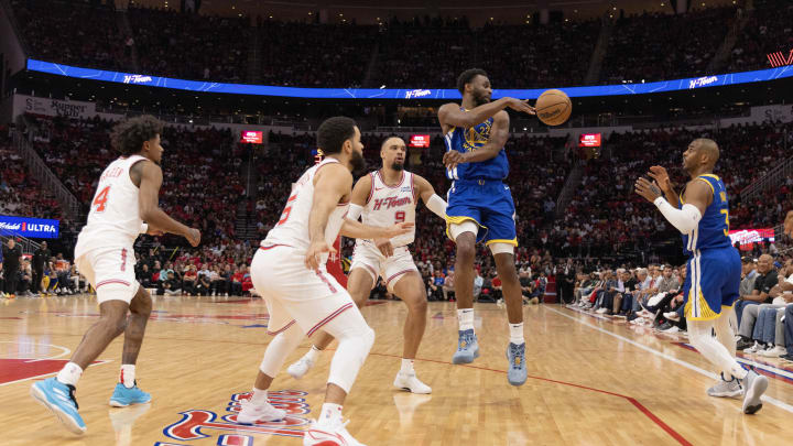 Apr 4, 2024; Houston, Texas, USA; Golden State Warriors forward Andrew Wiggins (22) passes to guard Apr 4, 2024; Houston, Texas, USA; Golden State Warriors forward Andrew Wiggins (22) passes to guard