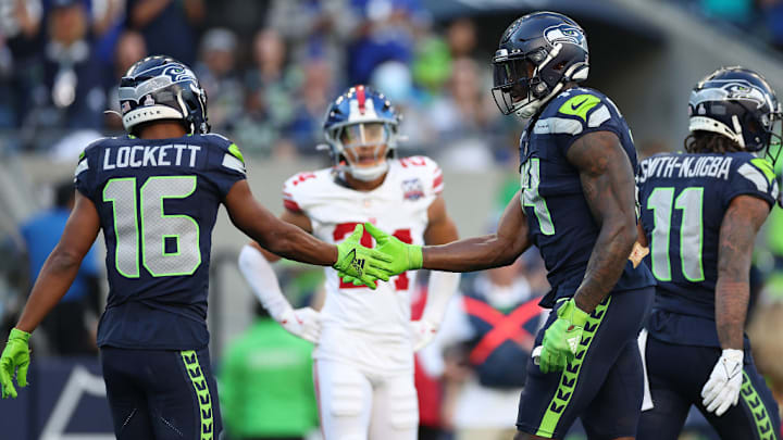 SEATTLE, WASHINGTON - OCTOBER 06: Tyler Lockett #16 and DK Metcalf #14 of the Seattle Seahawks react during the fourth quarter against the New York Giants at Lumen Field on October 06, 2024 in Seattle, Washington. 