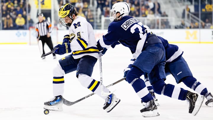 Mar 7, 2025; Ann Arbor, MI, USA; Michigan Wolverines defensman Tyler Duke (5) and Penn State defense Cade Christenson (27) battle for the puck in the third period of a Big Ten Tournament quarter final game at Yost Arena. Mandatory Credit: Rick Osentoski-Imagn Images Mar 7, 2025; Ann Arbor, MI, USA; Michigan Wolverines defensman Tyler Duke (5) and Penn State defense Cade Christenson (27) battle for the puck in the third period of a Big Ten Tournament quarter final game at Yost Arena. Mandatory Credit: Rick Osentoski-Imagn Images