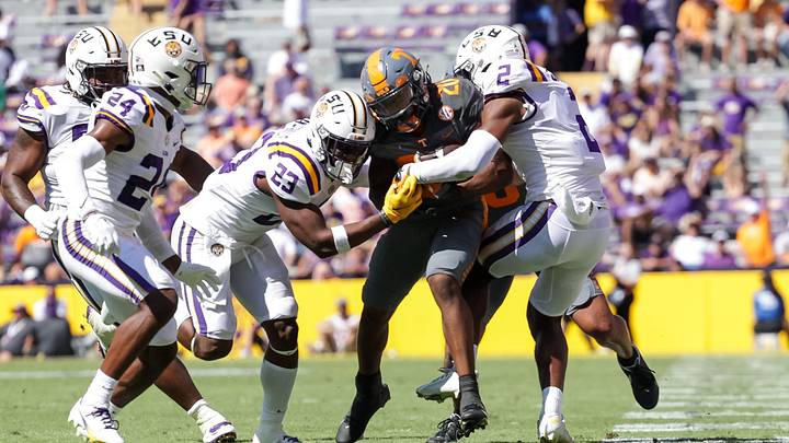 Tennessee Volunteers running back Jaylen Wright (20) is tackled by LSU Tigers linebacker Micah Baskerville (23) and cornerback Mekhi Garner (2) during the second half at Tiger Stadium. Tennessee Volunteers running back Jaylen Wright (20) is tackled by LSU Tigers linebacker Micah Baskerville (23) and cornerback Mekhi Garner (2) during the second half at Tiger Stadium.