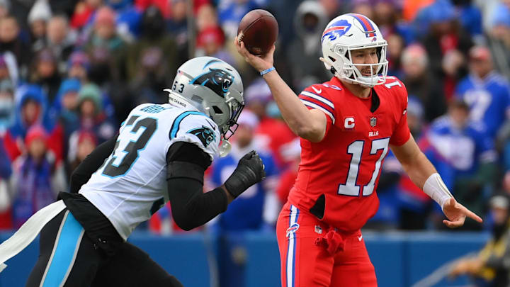 Dec 19, 2021; Orchard Park, New York, USA; Buffalo Bills quarterback Josh Allen (17) passes the ball as Carolina Panthers defensive end Brian Burns (53) defends during the first half at Highmark Stadium. Dec 19, 2021; Orchard Park, New York, USA; Buffalo Bills quarterback Josh Allen (17) passes the ball as Carolina Panthers defensive end Brian Burns (53) defends during the first half at Highmark Stadium.