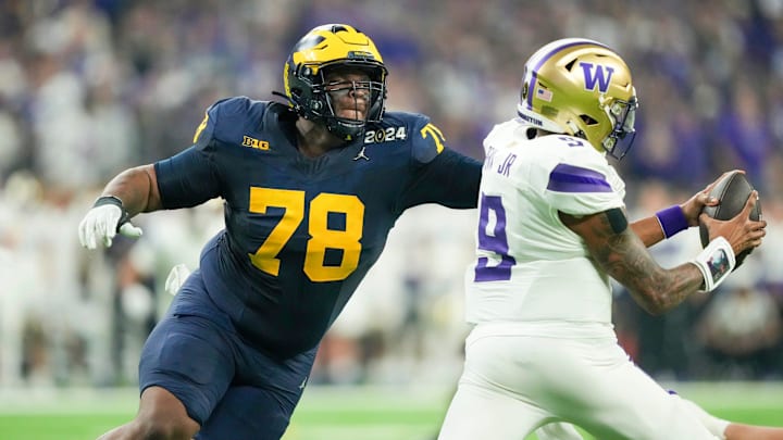Michigan defensive lineman Kenneth Grant reaches out to sack Washington quarterback Michael Penix Jr. in the second quarter during the College Football Playoff national championship game against Washington at NRG Stadium in Houston, Texas on Monday, Jan. 8, 2024. Michigan defensive lineman Kenneth Grant reaches out to sack Washington quarterback Michael Penix Jr. in the second quarter during the College Football Playoff national championship game against Washington at NRG Stadium in Houston, Texas on Monday, Jan. 8, 2024.