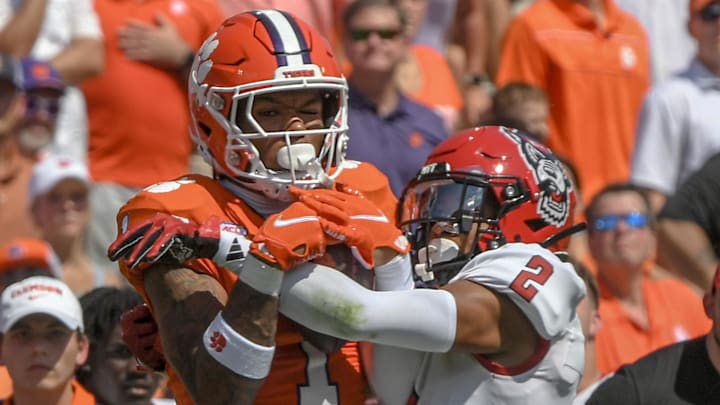 Sep 21, 2024; Clemson, South Carolina, USA; Clemson Tigers wide receiver T.J. Moore (1) catches a pass against North Carolina State Wolfpack cornerback Brandon Cisse (2) during the first quarter at Memorial Stadium. Mandatory Credit: Ken Ruinard-Imagn Images