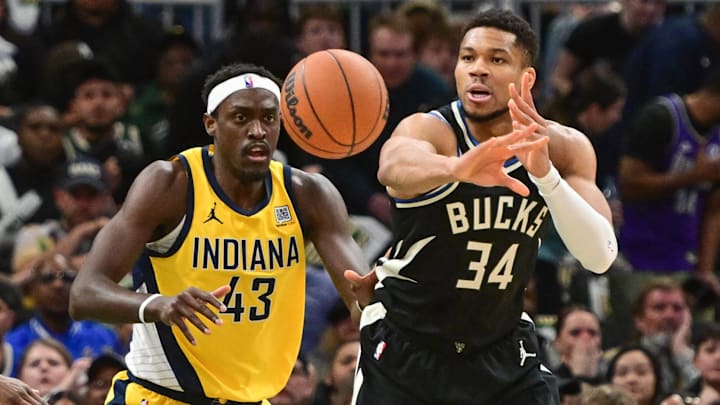 Apr 27, 2025; Milwaukee, Wisconsin, USA; Milwaukee Bucks forward Giannis Antetokounmpo (34) passes the ball away from Indiana Pacers forward Pascal Siakam (43) in the first quarter during game four of first round for the 2024 NBA Playoffs at Fiserv Forum. Mandatory Credit: Benny Sieu-Imagn Images
