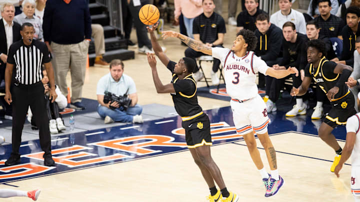 Missouri Tigers guard Marques Warrick (1) draws a foul on Auburn Tigers forward Jahki Howard (3) as Auburn Tigers take on Missouri Tigers at Neville Arena in Auburn, Ala., on Saturday, Jan. 4, 2025. Auburn Tigers defeated Missouri Tigers 84-68.