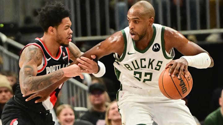 Jan 4, 2025; Milwaukee, Wisconsin, USA; Milwaukee Bucks forward Khris Middleton (22) is guarded by Portland Trail Blazers guard Anfernee Simons (1) in he first quarter at Fiserv Forum. Mandatory Credit: Benny Sieu-Imagn Images