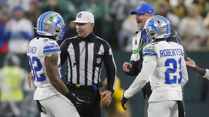 Nov 3, 2024; Green Bay, Wisconsin, USA; Detroit Lions head coach Dan Campbell yells at safety Brian Branch (32) as Branch argues with referee Clete Blakeman (34) after being ejected from a game against the Green Bay Packers at Lambeau Field. Mandatory Credit: Tork Mason-Imagn Images