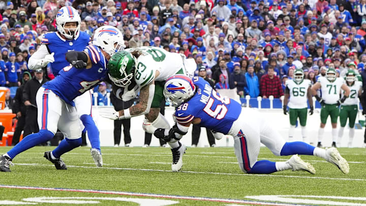 Dec 29, 2024; Orchard Park, New York, USA; Buffalo Bills linebacker Terrel Bernard (43) and Buffalo Bills linebacker Matt Milano (58) tackle New York Jets tight end Tyler Conklin (83)