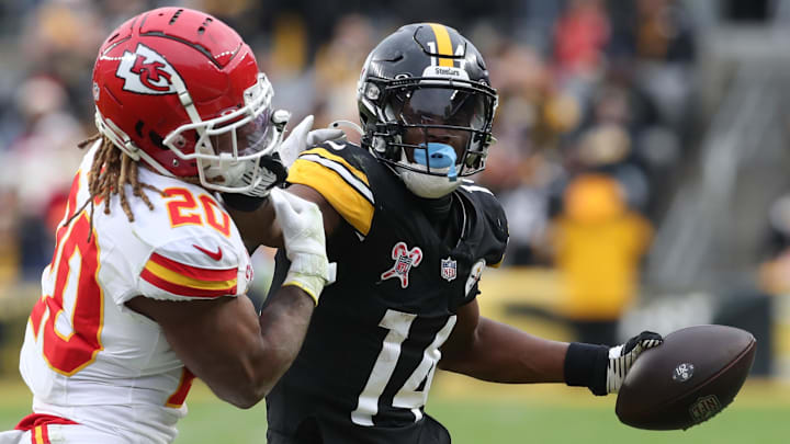 Pittsburgh Steelers wide receiver George Pickens runs after a catch as Kansas City Chiefs safety Justin Reid defends during the fourth quarter  at Acrisure Stadium. 