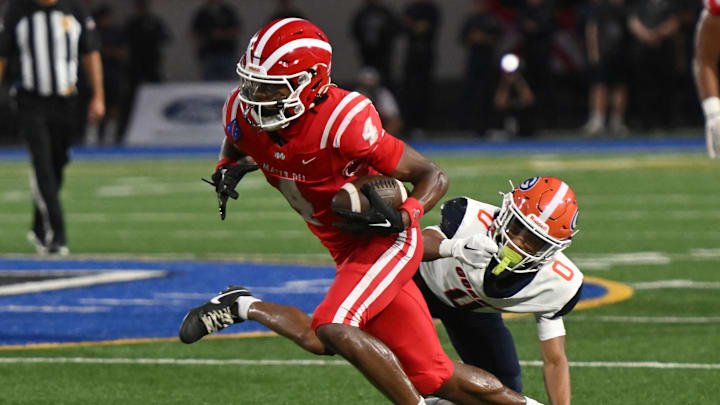 Mater Dei’s Kayden Dixon-Wyatt catches a pass and eludes a Bishop Gorman defender on Friday, September 6, 2024. Mater Dei’s Kayden Dixon-Wyatt catches a pass and eludes a Bishop Gorman defender on Friday, September 6, 2024.