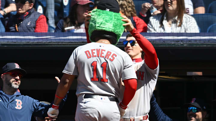 Apr 27, 2025; Cleveland, Ohio, USA; Boston Red Sox left fielder Jarren Duran (16) puts the Wally the Green Monster head on designated hitter Rafael Devers (11) after Devers hit a home run during the sixth inning against the Cleveland Guardians at Progressive Field. Mandatory Credit: Ken Blaze-Imagn Images