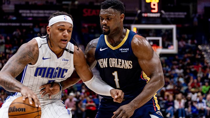 Mar 13, 2025; New Orleans, Louisiana, USA;  Orlando Magic forward Paolo Banchero (5) dribbles against New Orleans Pelicans forward Zion Williamson (1) during the first half at Smoothie King Center. Mandatory Credit: Stephen Lew-Imagn Images