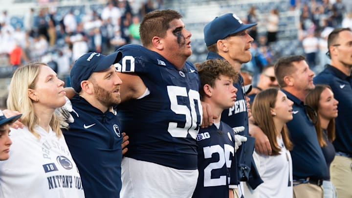Penn State offensive lineman Cooper Cousins (50) joins the alma mater following the Nittany Lions' 46-11 win over Nevada at Beaver Stadium.