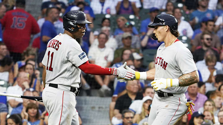 Jul 14, 2023; Chicago, Illinois, USA; Boston Red Sox left fielder Jarren Duran (16) is greeted by third baseman Rafael Devers (11) after scoring against the Chicago Cubs during the third inning at Wrigley Field.