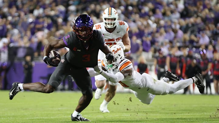 TCU Horned Frogs wide receiver Savion Williams (3) is tackled by Oklahoma State Cowboys safety Dylan Smith (11).