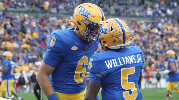 Pittsburgh Panthers quarterback Mason Heintschel (6) and wide receiver Raphael Williams Jr. (5)