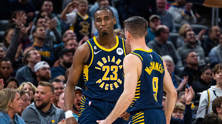 Mar 29, 2023; Indianapolis, Indiana, USA; Indiana Pacers forward Aaron Nesmith (23) and guard T.J. McConnell (9) celebrate a made shot in the second half against the Milwaukee Bucks at Gainbridge Fieldhouse. Mandatory Credit: Trevor Ruszkowski-Imagn Images