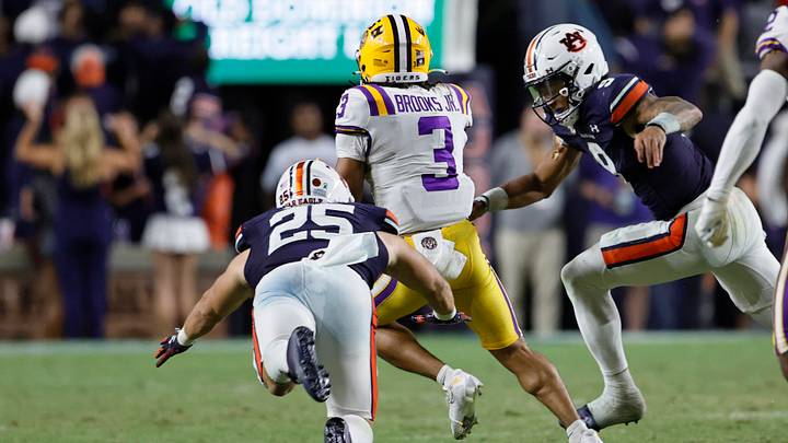 Oct 1, 2022; Auburn, Alabama, USA;  LSU Tigers safety Greg Brooks Jr. (3) is tackled by Auburn Tigers quarterback Robby Ashford (9) and tight end John Samuel Shenker (25) after intercepting a pass by Ashford during the fourth quarter at Jordan-Hare Stadium. Mandatory Credit: John Reed-USA TODAY Sports