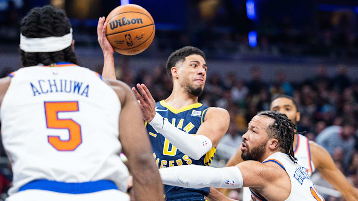 Feb 11, 2025; Indianapolis, Indiana, USA: Indiana Pacers guard Tyrese Haliburton (0) passes the ball while New York Knicks guard Jalen Brunson (11) defends in the first half at Gainbridge Fieldhouse. Mandatory Credit: Trevor Ruszkowski-Imagn Images