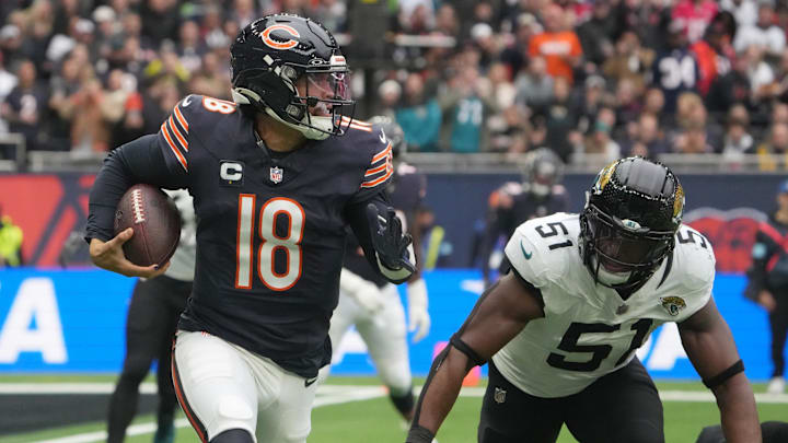 Oct 13, 2024; London, United Kingdom; Chicago Bears quarterback Caleb Williams (18) carries the ball against Jacksonville Jaguars linebacker Ventrell Miller (51) in the first half during an NFL International Series game at Tottenham Hotspur Stadium. 