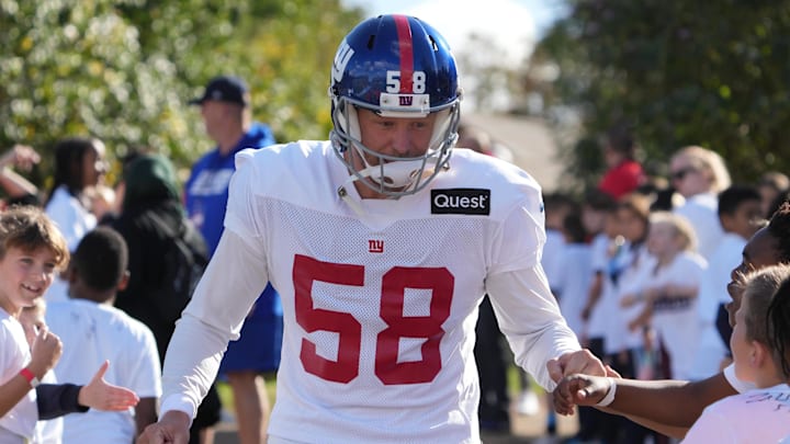 Oct 7,, 2022; Thundridge, United Kingdom; New York Giants long snapper Casey Kreiter (58) is greeted by children during practice at Hanbury Manor. Mandatory Credit: Kirby Lee-Imagn Images