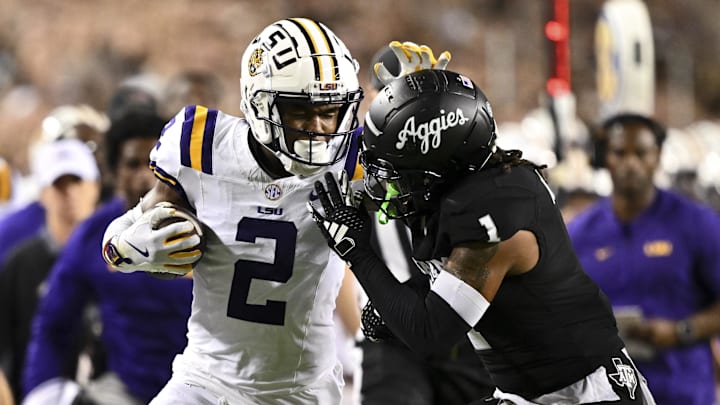 Oct 26, 2024; College Station, Texas, USA; LSU Tigers wide receiver Kyren Lacy (2) runs the ball as Texas A&M Aggies defensive back Bryce Anderson (1) defends during the second quarter. The Aggies defeated the Tigers 38-23; at Kyle Field. Mandatory Credit: Maria Lysaker-Imagn Images.  