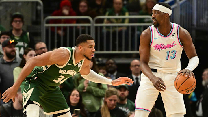 Jan 23, 2025; Milwaukee, Wisconsin, USA;  Miami Heat center Bam Adebayo (13) is guarded by Milwaukee Bucks forward Giannis Antetokounmpo (34) in the first quarter at Fiserv Forum. Mandatory Credit: Benny Sieu-Imagn Images