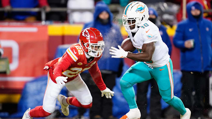 Miami Dolphins wide receiver Tyreek Hill (10) runs the ball ahead of Kansas City Chiefs cornerback Trent McDuffie (22) during the first half of the 2024 AFC wild card game at GEHA Field at Arrowhead Stadium. 