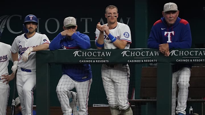 May 17, 2025; Arlington, Texas, USA; Texas Rangers shortstop Josh Smith (8), hitting coach Bret Boone (78), third baseman Josh Jung (6) and manager Bruce Bochy (15) look on the from the dugout during the sixth inning against the Houston Astros at Globe Life Field.
