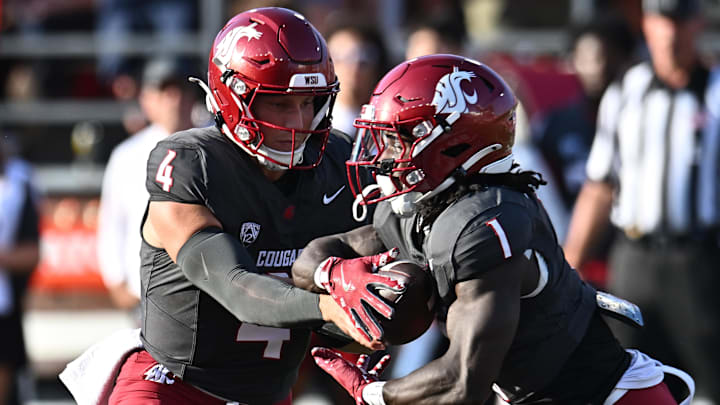 Sep 20, 2025; Pullman, Washington, USA; Washington State Cougars running back Angel Johnson (1) takes the hand off from Washington State Cougars quarterback Zevi Eckhaus (4) in the first half of Apple Cup against the Washington Huskies at Gesa Field at Martin Stadium. Mandatory Credit: James Snook-Imagn Images Sep 20, 2025; Pullman, Washington, USA; Washington State Cougars running back Angel Johnson (1) takes the hand off from Washington State Cougars quarterback Zevi Eckhaus (4) in the first half of Apple Cup against the Washington Huskies at Gesa Field at Martin Stadium. Mandatory Credit: James Snook-Imagn Images