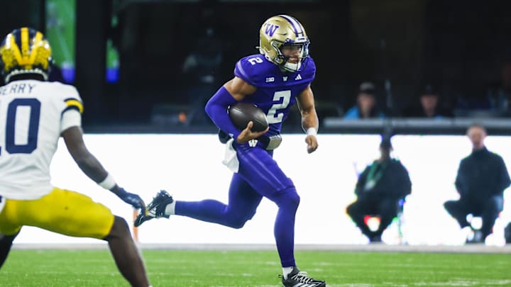 Oct 5, 2024; Seattle, Washington, USA; Washington Huskies quarterback Demond Williams Jr. (2) rushes against the Michigan Wolverines during the third quarter at Alaska Airlines Field at Husky Stadium. Mandatory Credit: Joe Nicholson-Imagn Images