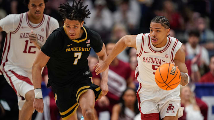 Arkansas guard Darius Acuff Jr. (5) drives around Vanderbilt guard Chandler Bing (7) during the first half of the SEC tournament championship game at Bridgestone Arena in Nashville, Tenn., Sunday, March 15, 2026.