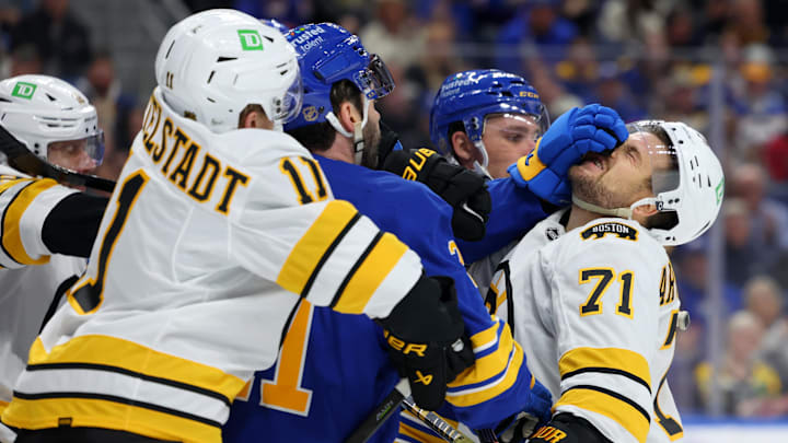 Mar 25, 2026; Buffalo, New York, USA;  The Boston Bruins and the Buffalo Sabres players get into a scrum after the whistle during the first period at KeyBank Center. Mandatory Credit: Timothy T. Ludwig-Imagn Images
