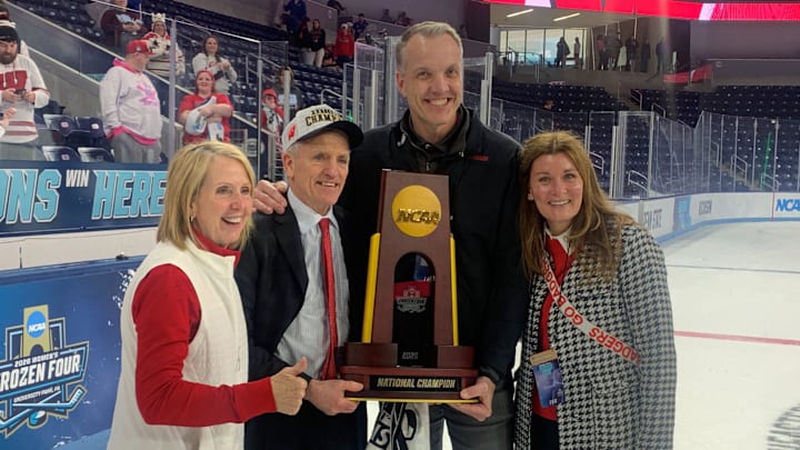 Wisconsin coach Mark Johnson and athletic director Chris McIntosh pose with the championship trophy after the Badgers won the NCAA women's hockey championship at Pegula Ice Arena in University Park, Pa. on March 22, 2026 Wisconsin coach Mark Johnson and athletic director Chris McIntosh pose with the championship trophy after the Badgers won the NCAA women's hockey championship at Pegula Ice Arena in University Park, Pa. on March 22, 2026