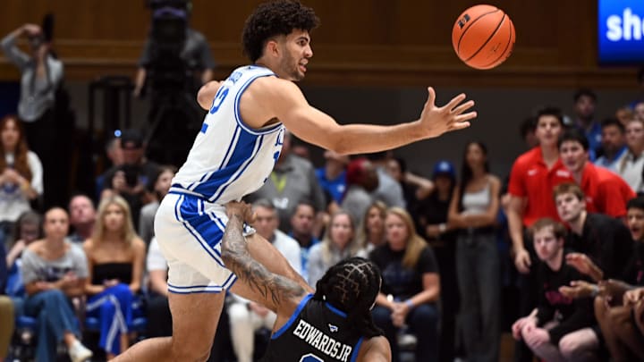 Jan 10, 2026; Durham, North Carolina, USA;Duke Blue Devils forward Cameron Boozer (12) loses a ball out of bounds in front of Southern Methodist Mustangs guard B.J. Edwards (0) during the first half at Cameron Indoor Stadium. Mandatory Credit: Rob Kinnan-Imagn Images