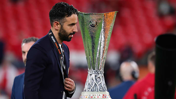 Ruben Amorim accepts his runner-up medal passing by the trophy he nearly lifted in his first six months.