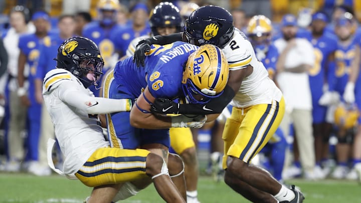 Oct 12, 2024; Pittsburgh, Pennsylvania, USA;  California Golden Bears defensive back Miles Williams (left) and defensive back Craig Woodson (2) tackle Pittsburgh Panthers tight end Gavin Bartholomew (86) during the fourth quarter against at Acrisure Stadium. Pittsburgh won 17-15. Mandatory Credit: Charles LeClaire-Imagn Images