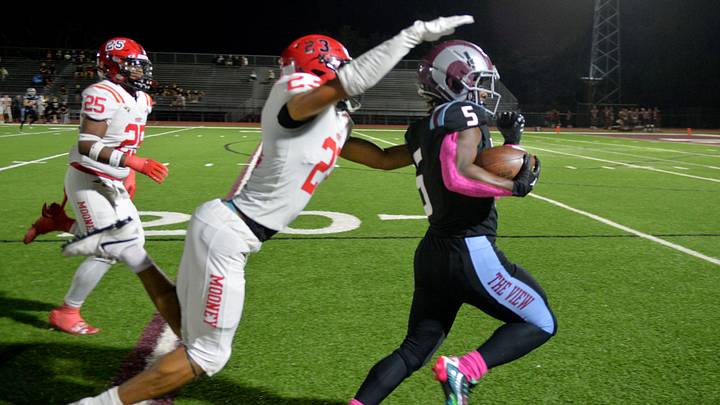 Cardinal Mooney defensive back Jayden Burnett (#23) makes a touchdown-saving tackle after a big gain by Riverview running back Isaiah Belt (#5) in the second quarter. The Riverview High Rams hosted the Cardinal Mooney Catholic High Cougars Friday evening, Oct. 18, 2024 in Sarasota.