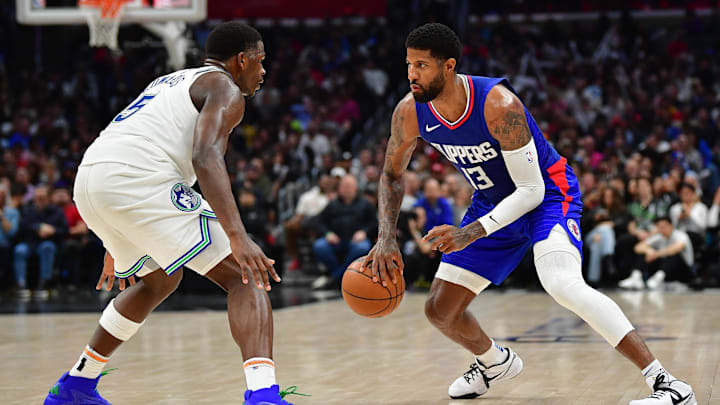 Mar 12, 2024; Los Angeles, California, USA; Los Angeles Clippers forward Paul George (13) controls the ball against Minnesota Timberwolves guard Anthony Edwards (5) during the second half at Crypto.com Arena. Mandatory Credit: Gary A. Vasquez-Imagn Images